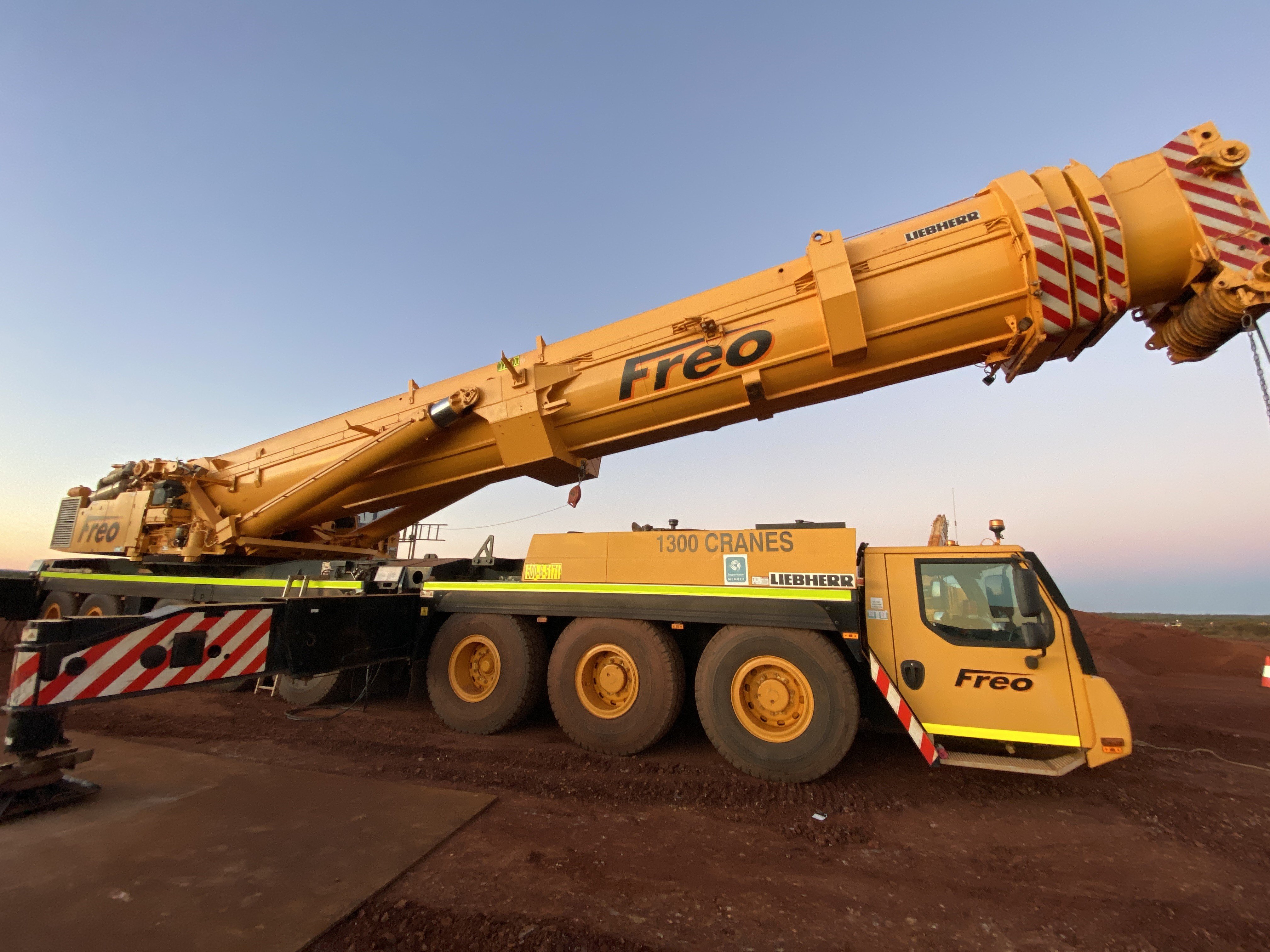side view of an All Terrain Crane Truck which is a special purpose vehicle and it has it's mast slightly raised