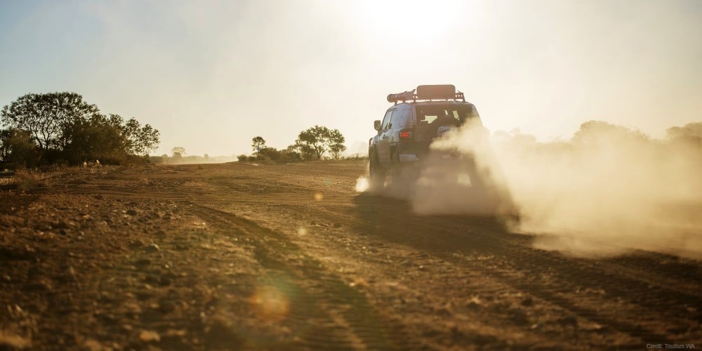 Car driving on unsealed road in regional WA
